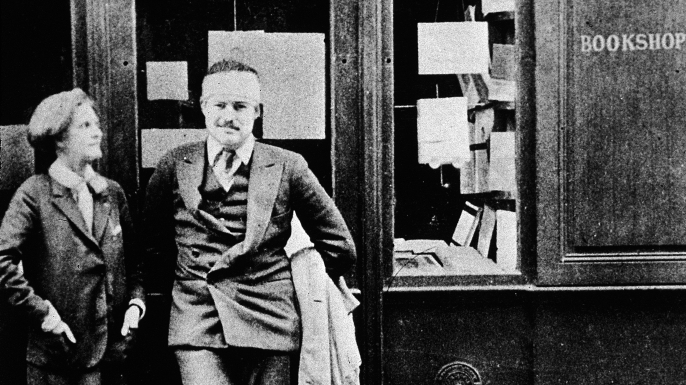 Hemingway and bookseller Sylvia Beech outside Beech's Paris store, Shakespeare and Company, 1920s.