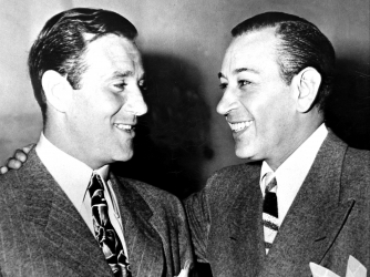 Benjamin Bugsy Siegel talks to George Raft. (Credit: NY Daily News Archive/Getty Images)