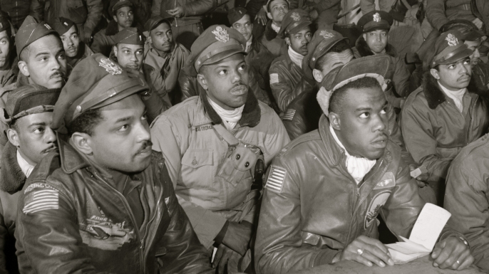 Tuskegee airmen attending a briefing in Italy in 1945. First row (l-r): Hiram E. Man, unidentified airman, Newman C. Golden, Bertram W. Wilson Jr., Samuel W. Watts Jr., Second row (l-R): Armour G. McDemoe, Howard C. Gamble, Harry T. Steward, Jr, Earle R. Lane, Wickliffe, Wyrain T. Shell, Harold M. Morris, John E. Edwards, John H. Porter, James H. Fischer, Wyrain T. Shell. Third row (l-r): William E. "Porky" Rice, Tony Weaver, Charles L. White, George Arnold Lynch, Samuel L. Washington, Calvin J. Spann, Frank N. Wright. (Credit: Buyenlarge/Getty Images)