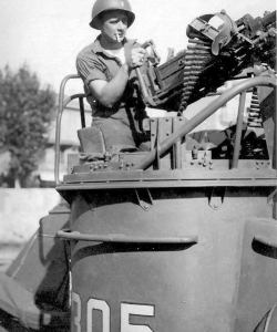 An unidentified serviceman handles PT-305’s port-side .50-caliber Browning machine gun, or “gun tub.” (Gift of Cathy Kaminski/Courtesy of The National WWII Museum)