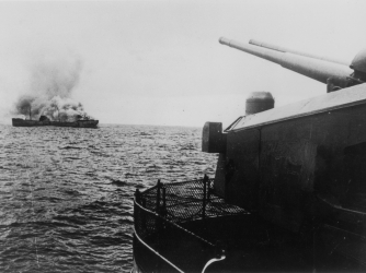 A view of the German battleship Bismarck firing on a merchant ship in the north Atlantic. (Credit: Keystone/Getty Images)