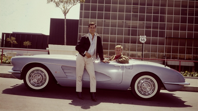 American actors George Maharis (standing) and Martin Milner pose with their blue Corvet from the television show 'Route 66.' (Credit: CBS Photo Archive/Getty Images)