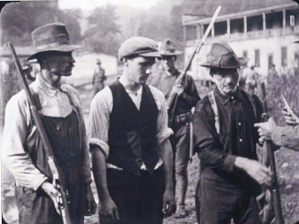 Miners from Battle of Blair Mountain giving up their guns.