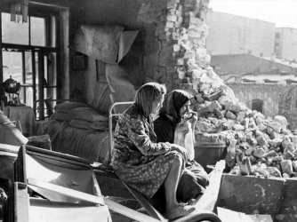 Two women sitting among the debris in the aftermath of the German bombardment of Leningrad. (Credit: D. Trakhtenberg / Getty Images)