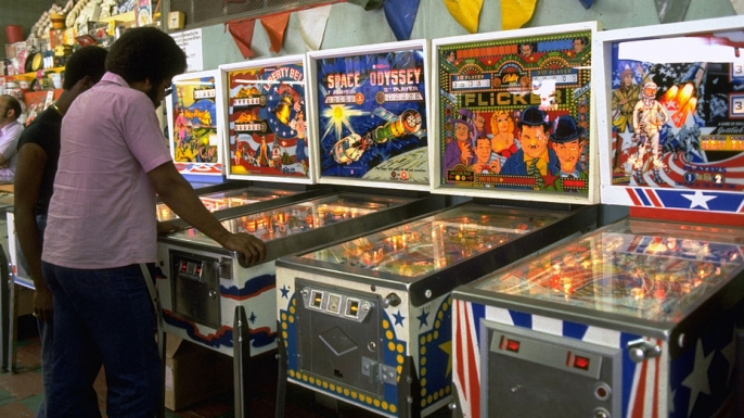 Men playing pinball in a Coney Island arcade, 1977. (Credit: Carl Mydans/The LIFE Images Collection/Getty Images)