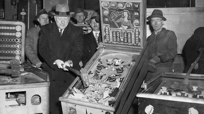 New York City Police Commissioner William P. O'Brien smashes illegal pinball machines in a warehouse in the Greenpoint section of Brooklyn. (Credit: Bettmann/Getty Images)