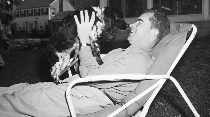 GOP Vice Presidential candidate Sen. Richard Nixon of California relaxes at home in Washington with the family pet, a Cocker Spaniel named "Checkers." (Credit: Bettmann/Getty Images)