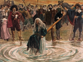 An accused witch going through the judgement trial, where she is dunked in water to prove her guilt of practicing witchcraft. (Credit: Bettmann/Getty Images)
