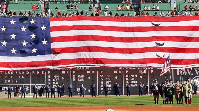 The giant American flag is unfurled as part of pre-game festivities on Patriots' Day. (Credit: Jim Davis/The Boston Globe/Getty Images)