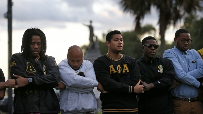 Graduate members of Alpha Phi Alpha Fraternity, Inc. pray during a vigil across the street from the Jefferson Davis monument on May 4, 2017. The group supports the removal of Confederate monuments.