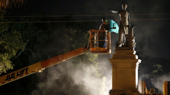 Workers prepare to take down the Jefferson Davis statue in New Orleans, Thursday, May 11, 2017. This was the second of four Confederate monuments slated for removal in a contentious process that has sparked protests on both sides. (AP Photo/Gerald Herbert)