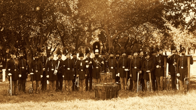 Group portrait of the band, 24 uniformed men, many of whom are holding musical instruments, Fort Monroe, VA, 1864. They are wearing hats with plumes. (Credit: Buyenlarge/Getty Images)