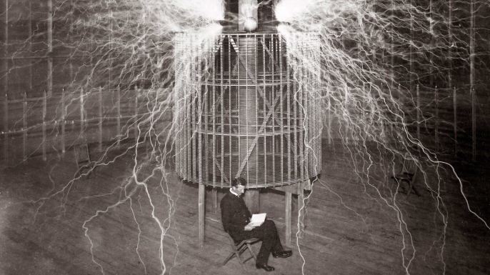 Nilkola Tesla sitting in his Colorado Spring laboratory.