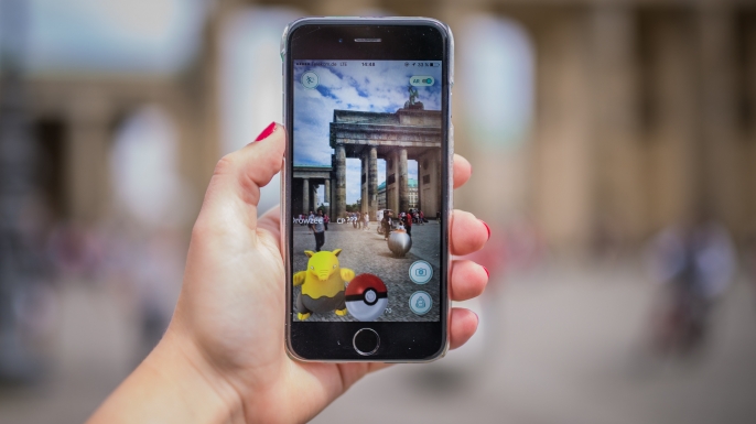 A woman points her smart phone at the Brandenburg Gate as she plays the Pokemon Go mobile game. (Credit: SOPHIA KEMBOWSKI/AFP/Getty Images)