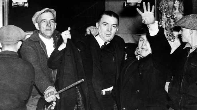Miles Sweeney, one of the strike leaders at the Hershey Chocolate Plant, being ejected by a mob of non-striking workers and local farmers. (Credit: Everett Collection Historical/Alamy Stock Photo)
