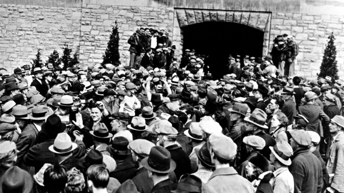 Mob of non-striking workers and local farmers allowing some of the 600 striking leave the factory peacefully with their arms raised. More belligerent strikers were ejected by the mob of people, with 25 injured, some of which were hospitalized. (Credit: Everett Collection Historical/Alamy Stock Photo)