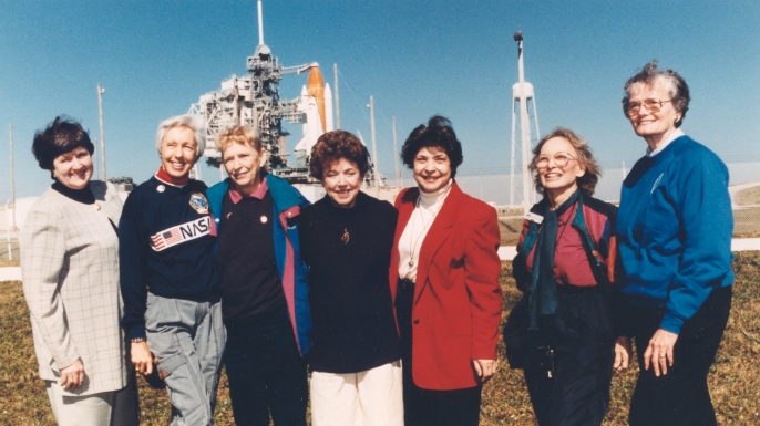 Members of the First Lady Astronaut Trainees (FLATs), also known as the "Mercury 13" (from left) Gene Nora Jessen, Wally Funk, Jerrie Cobb, Jerri Truhill, Sarah Rutley, Myrtle Cagle and Bernice Steadman. These seven women who once aspired to fly into space stand outside Launch Pad 39B near the Space Shuttle Discovery in this photograph from 1995. (Credit: NASA)