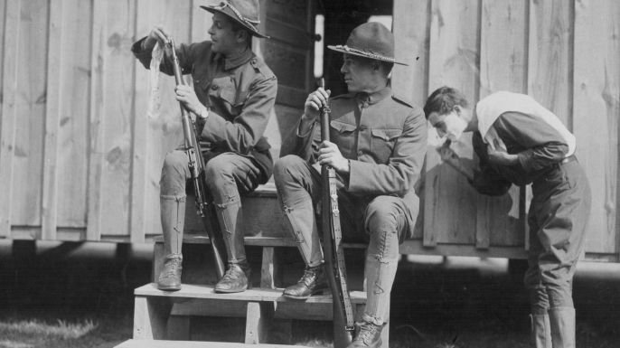 U.S. soldiers cleaning their rifles at a training camp in Plattsburg, New York during World War I. (Credit: Paul Thompson/FPG/Getty Images)