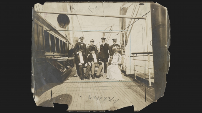 Photograph showing President Theodore Roosevelt, seated center, Secretary of the Navy William H. Moody, left, Mrs. Roosevelt, right; standing Sir Thomas Lipton, Admiral George Dewey, C. Oliver Iselin, and General Adna R. Chaffee on the deck of the Mayflower off Oyster Bay, Long Island, New York, 1903. (Credit: The Library of Congress)
