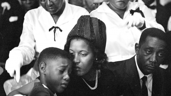 Mrs. Medgar Evers comforts her 9-year-old son, Darrel, at the funeral for integration leader and first Mississippi field secretary of the NAACP Medgar Evers. He was 37 when he was assassinated outside the family’s Jackson home. (Credit: AP Photo)