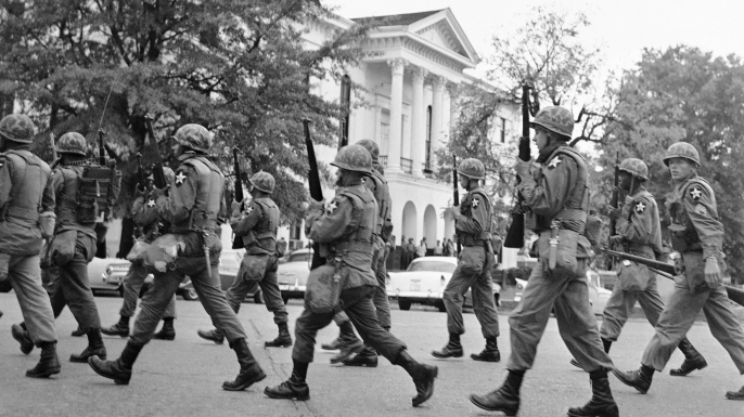 Army troops patrol past the famed courthouse square in downtown Oxford, Mississippi in the wake of student riots on the campus of Ole Miss. (Credit: AP Photo)