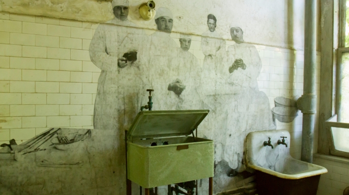 The installation Unframed Ellis Island by French artist JR. Here in the surgical wing is a vintage photograph of the surgical team. (Credit: Karen Foley Photography/Alamy Stock Photo)