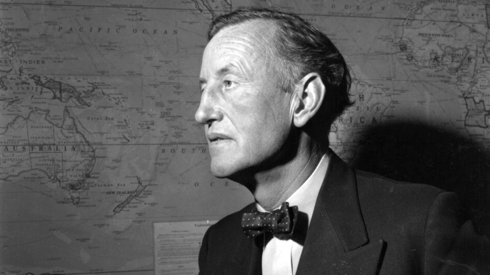 Ian Fleming (1908 - 1964), British author and creator of the character James Bond, in his study. (Credit: Express/Express/Getty Images)