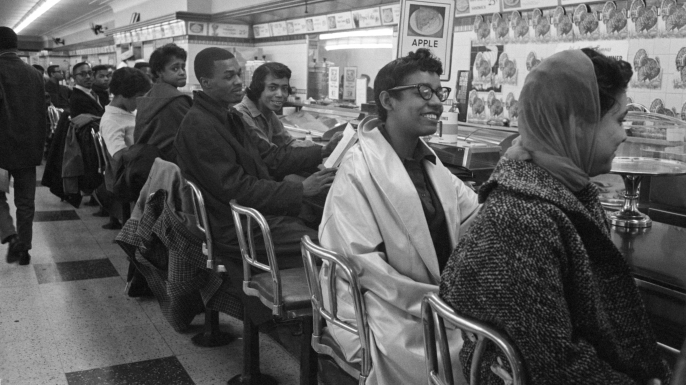 Students line the counter in protest for the stores refusal to serve them. (Credit: Bettmann/Getty Images)