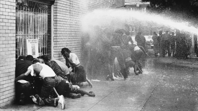 Protestors of the "Children's Crusade" being attacked by dogs and water cannons. (Credit: Michael Ochs Archives/Getty Images)