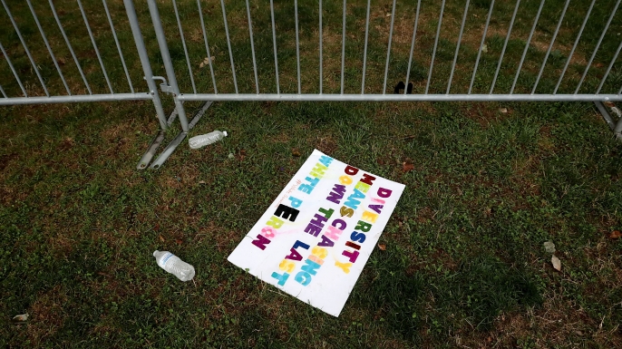 Signs left behind by white nationalists, neo-Nazis, the Ku Klux Klan and members of the 'alt-right' the day after the Unite the Right rally devolved into violence August 13, 2017 in Charlottesville, Virginia. The Charlottesville City Council voted to remove the statue and change the name of the space from Lee Park to Emancipation Park, sparking protests from racist groups. (Credit: Chip Somodevilla/Getty Images)