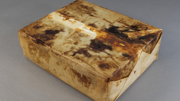 Huntley and Palmer's fruit cake in wrapper found in Cape Adare. (Credit: Antarctic Heritage Trust)