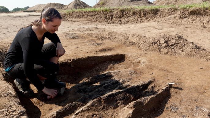 Nanna Holm, Chief Curator at the Danish Castle Center, working on excavated remains from burned wooden pillars which was part of the Northern gate in this newly found Viking Ring Castle, 2014. (Credit: OJPHOTOS/Alamy Stock Photo)