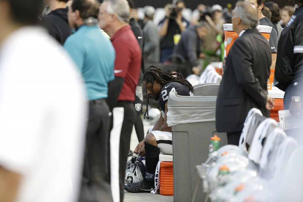 Oakland Raiders running back Marshawn Lynch sits on the bench during the national anthem before an NFL preseason football game, August 19, 2017. (Credit: Rich Pedroncelli/AP Photo)