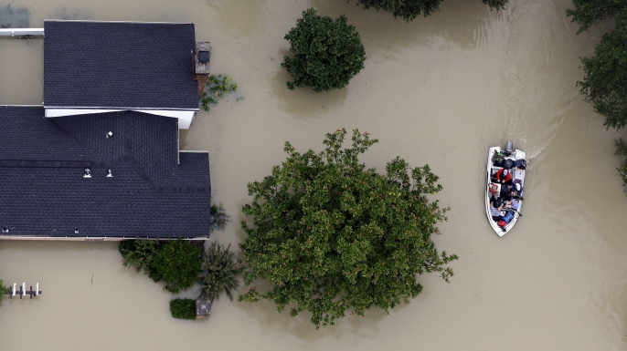 Residents evacuate their homes near the Addicks Reservoir as floodwaters from Hurricane Harvey rise in Houston. (Credit: David J. Phillip/AP Photo)