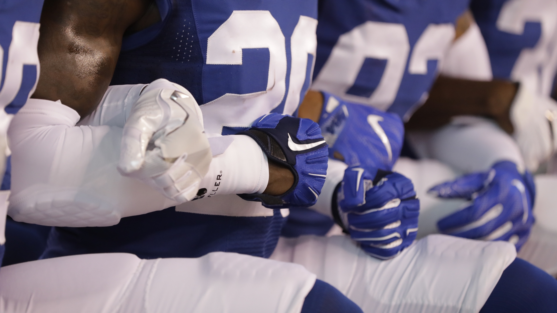 Members of the Indianapolis Colts lock arms as they take a knee during the Nation Anthem before an NFL football game against the Cleveland Browns in Indianapolis, September 24, 2017. (Credit: Darron Cummings/AP Photo)