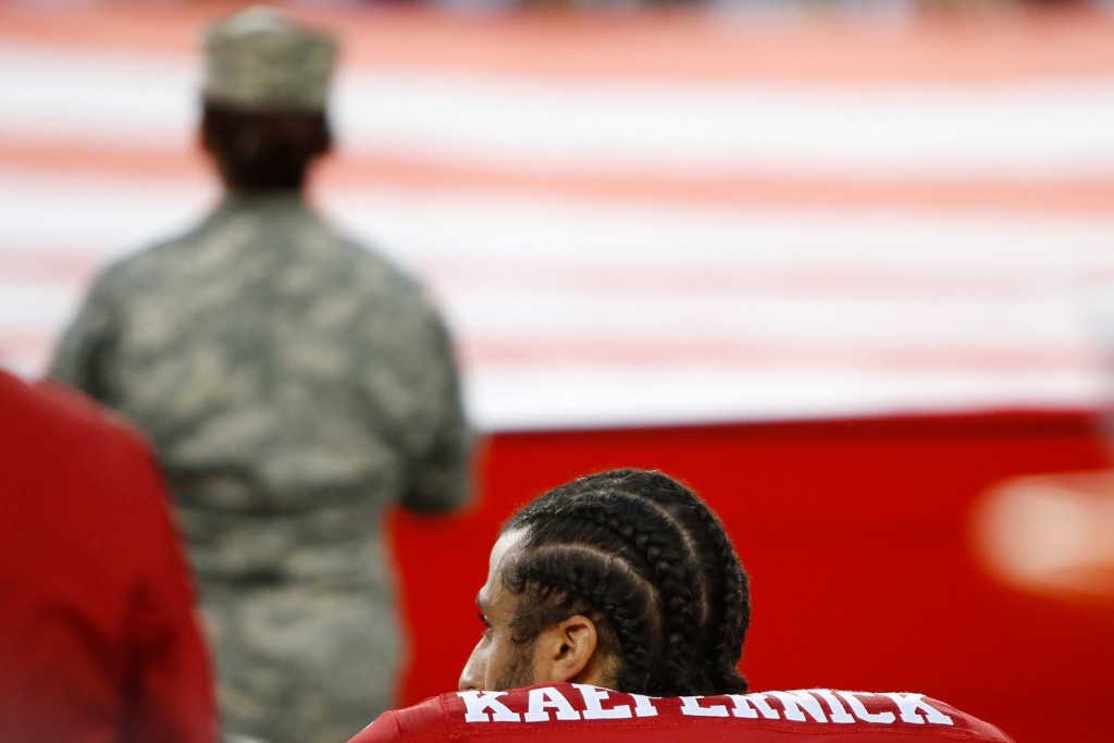 Colin Kaepernick, #7 of the San Francisco 49ers, kneels in protest during the national anthem. (Credit: Robert Reiners/Getty Images)