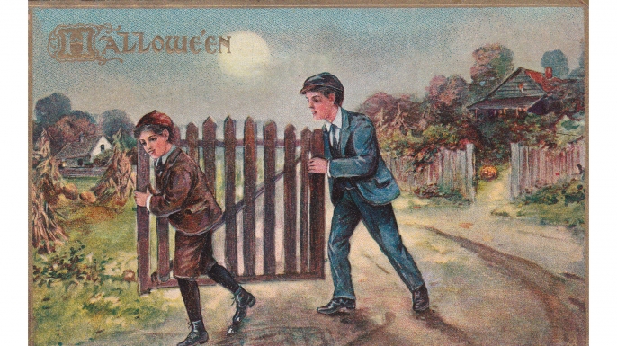 Vintage card showing two boys stealing a gate on Halloween night, 1911. (Courtesy of Lisa Morton)