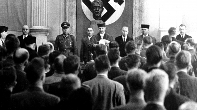 Roland Freisler, the President of the 'National Socialist People's Court' (Volksgerichtshof). Here he is reading out the verdict against the eight suspects of the assassination attempt on Hitler, the so-called July Plot, at the court in Berlin, 1944. (Credit: DPA/Picture-Alliance/AP Images)