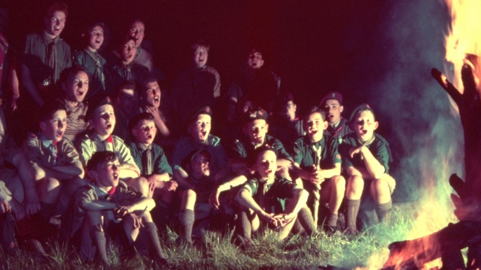 Scouts singing round the camp-fire. (Credit: Alex Dellow/Getty Images)