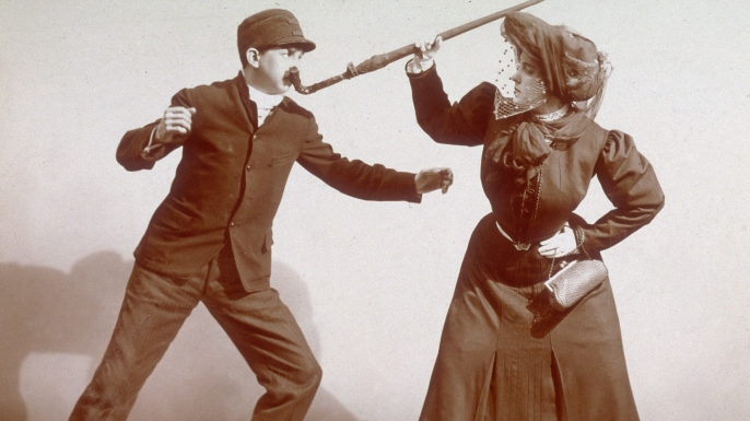 A woman using her umbrella during a 'Lesson In the Art of Womanly Self-Defense', 1906. (Credit: Museum of the City of New York/Byron Collection/Getty Images)