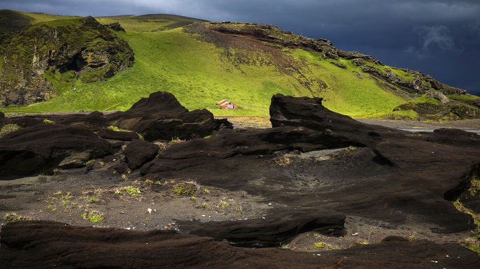 View of a red little house on a lava field near Vik, south of Iceland. (Credit: Joel Saget/AFP/Getty Images)