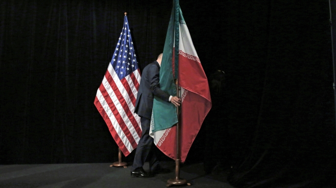 The Iranian and U.S. flag on stage, after a group picture with foreign ministers and representatives of US, Iran, China, Russia, Britain, Germany, France and the EU during the Iran nuclear talks at the Vienna International Center in Vienna on July 14, 2015. (Credit: CARLOS BARRIA/AFP/Getty Images)