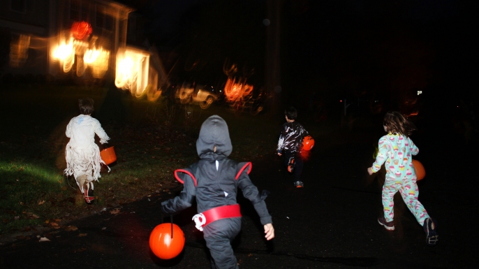 Children trick or treating on Halloween night. (Credit: Tim Clayton/Corbis via Getty Images)