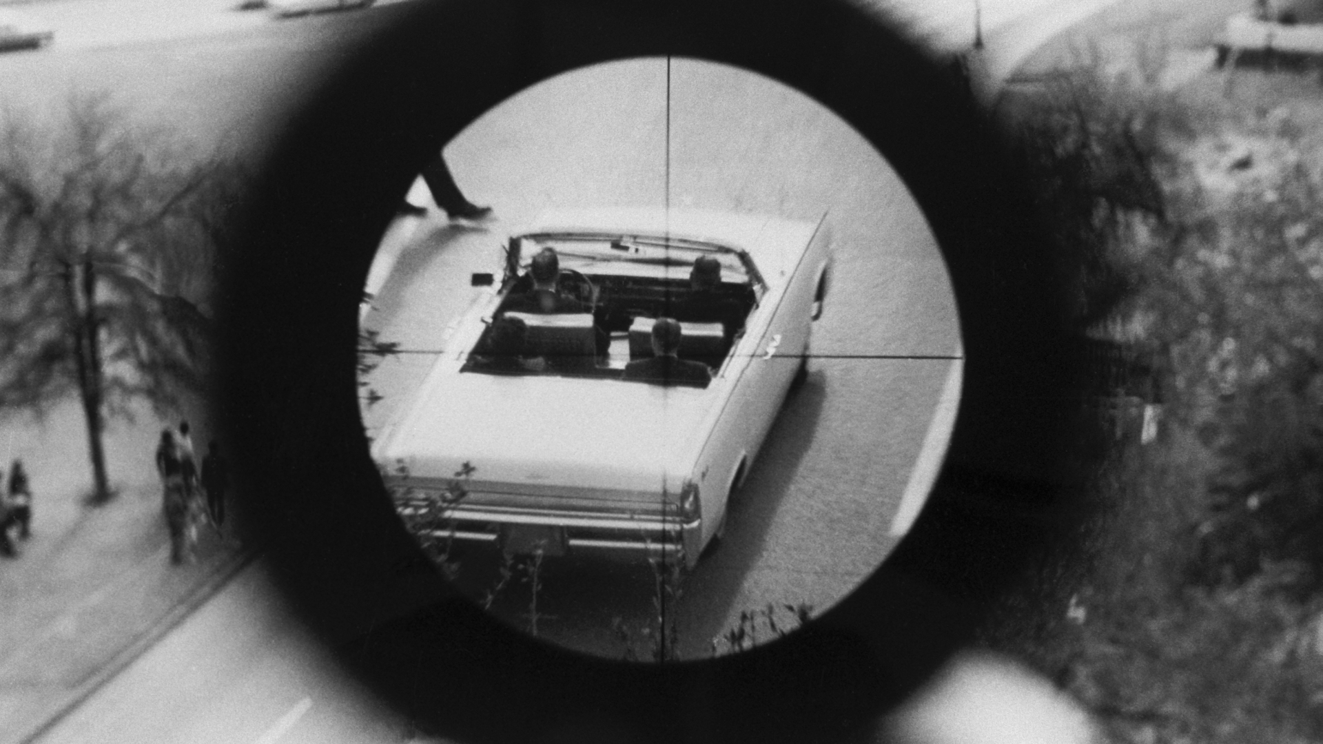 A view through a gun sight from the Texas School Book Depository is part of a reenactment of the Kennedy assassination. This evidence was submitted to the Warren Commission. (Credit: Corbis via Getty Images)