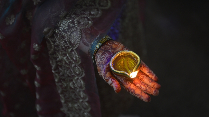 A Pakistani Hindu family offers prayers and light candles as they mark Diwali, the Festival of Lights, in Lahore, 2016. (Credit: Arif Ali/AFP/Getty Images)