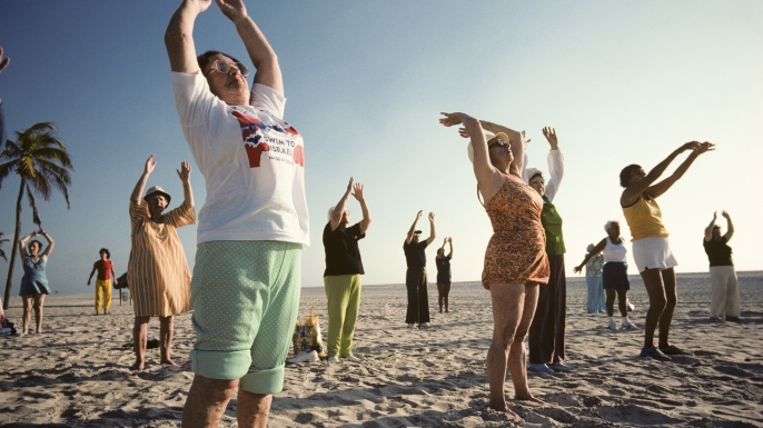 Elderly people doing outdoor early morning exercises in a class on Miami Beach. (Credit: Nathan Benn/Corbis via Getty Images)