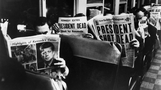 Commuters reading of John F. Kennedy's assassination, 1963. (Credit: Carl Mydans/The LIFE Picture Collection/Getty Images)
