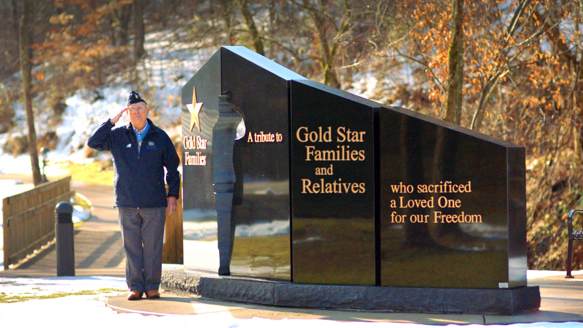 Hershel "Woody" Williams saluting next to the Gold Star Families Memorial Monument. This monument is to honor Gold Star Families, preserve the memory of the fallen, and stand as a stark reminder that Freedom is not free. (Courtesy of the Hershel Woody Williams Medal of Honor Foundation)