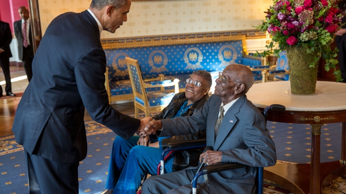 President Barack Obama greets Richard Overton, with Earlene Love-Karo, before attending a Veteran's Day Breakfast at the White House, 2013. (Credit: 506 Collection/Alamy Stock Photo)