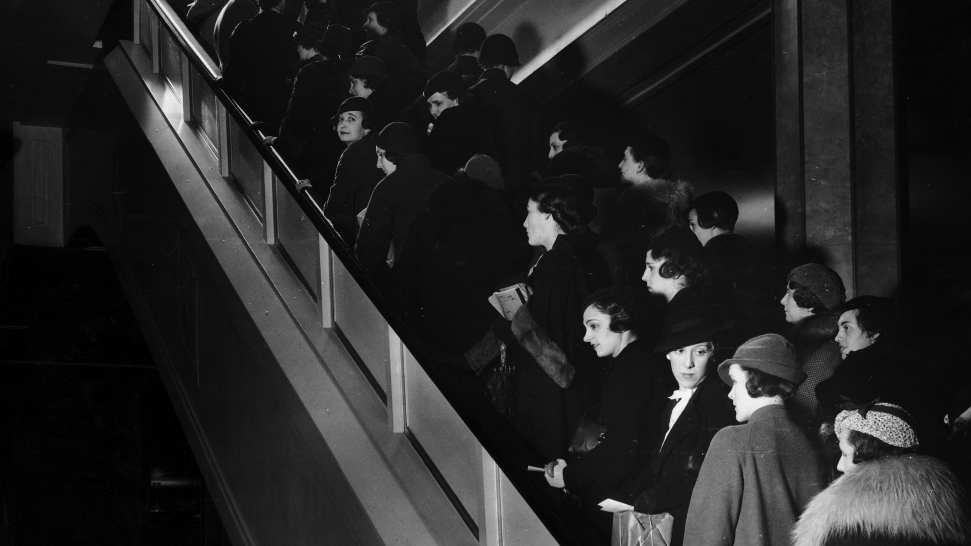 A crowd of shoppers on an escalator inside a department store in New York City, 1935. (Credit: Hulton Archive/Getty Images)